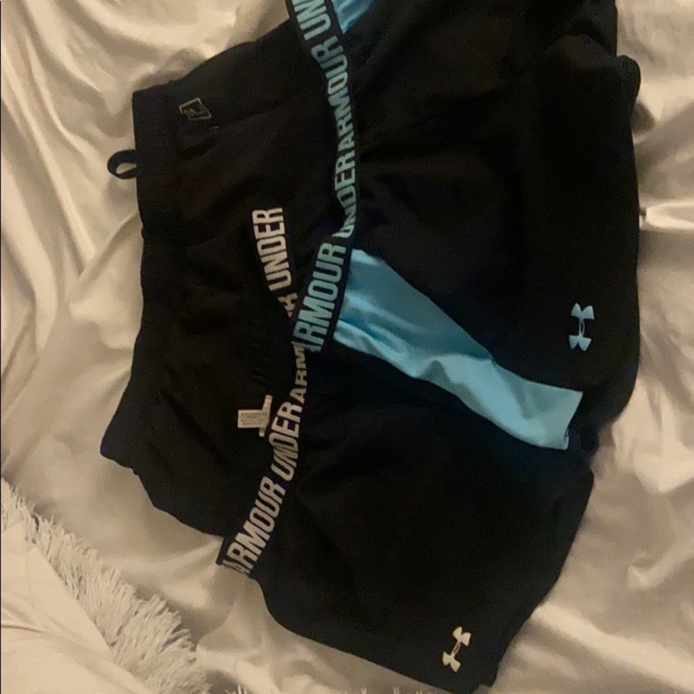 Two under armor shorts one Fila short